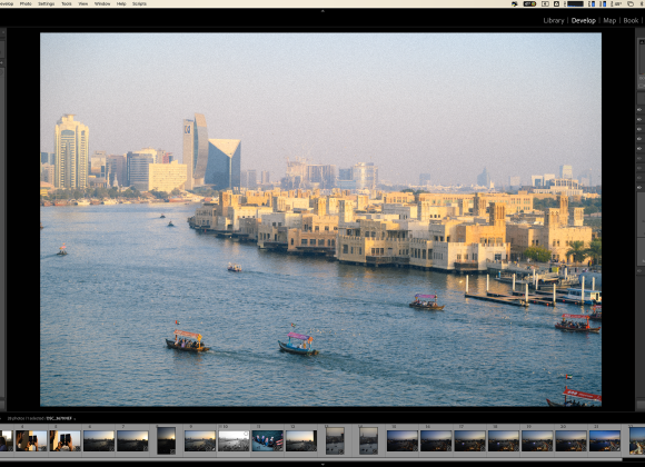 A cityscape with boats on a river, viewed in a photo editing software interface.