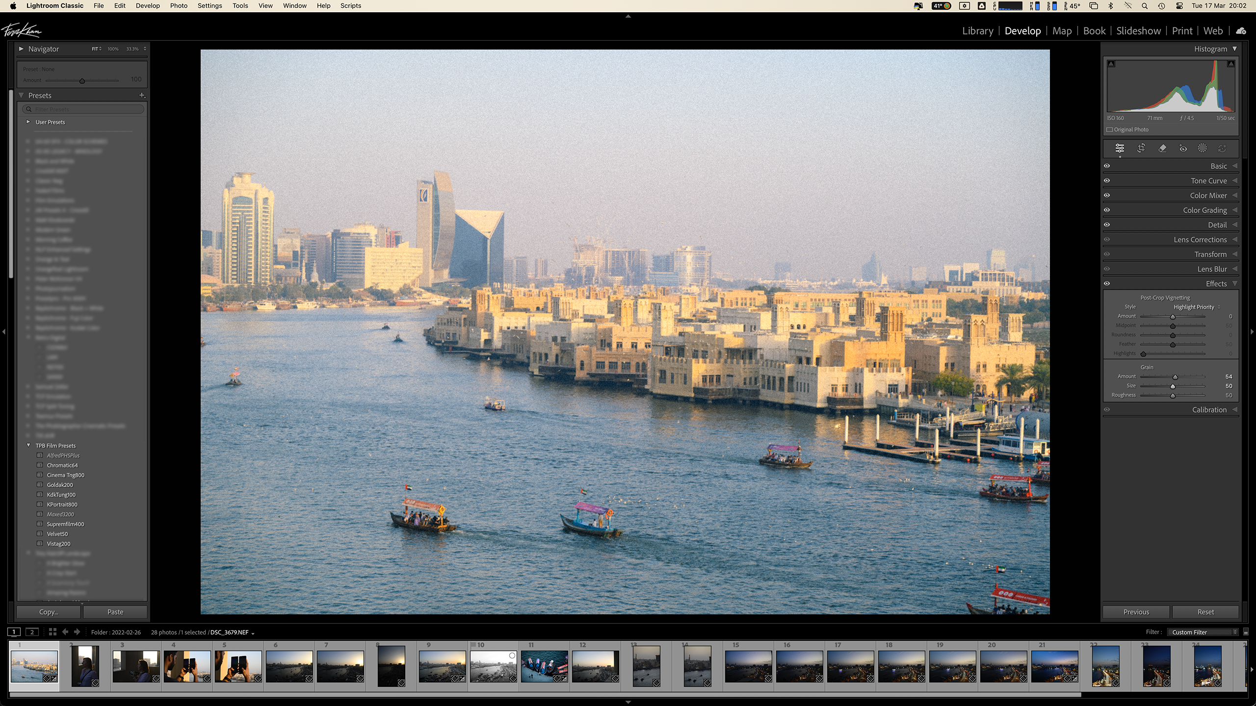 A cityscape with boats on a river, viewed in a photo editing software interface.