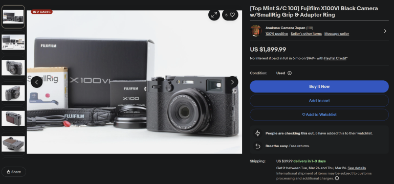 Fujifilm X100VI black camera with accessories, box, and manual displayed on a white surface.