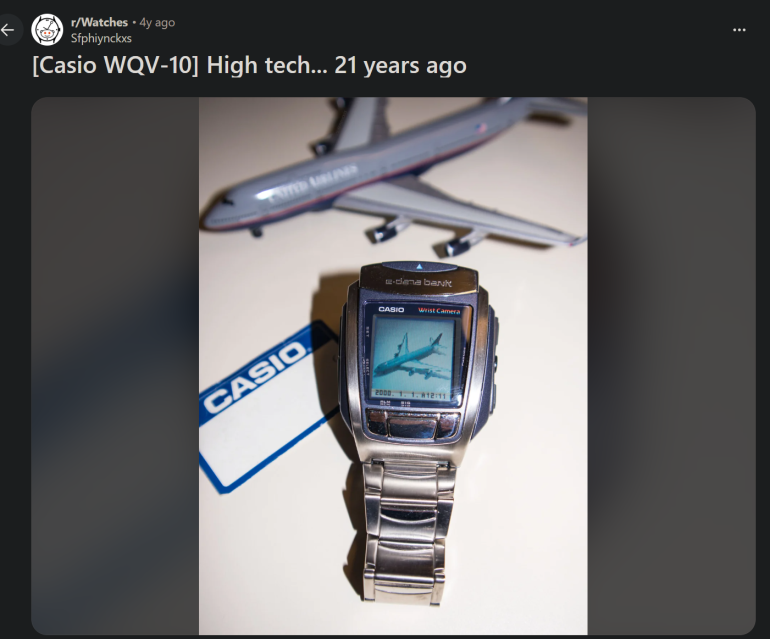 A Casio WQV-10 watch displaying a jet, placed next to a model airplane and a Casio card.