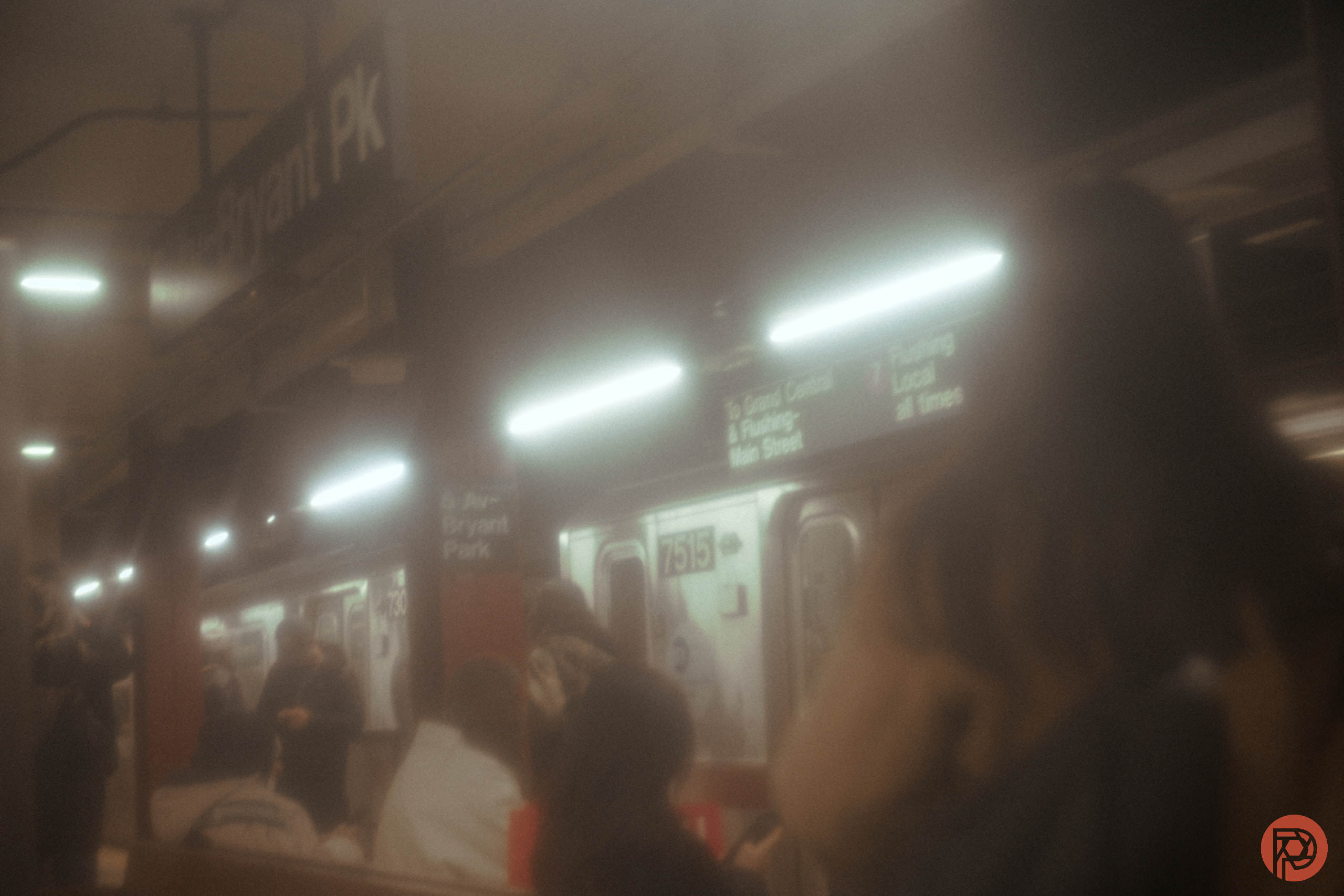 What Happens When You Put a Sandwich Bag Over a Lens? Soft-focus photo of people waiting for a subway train at Bryant Park station in New York City.