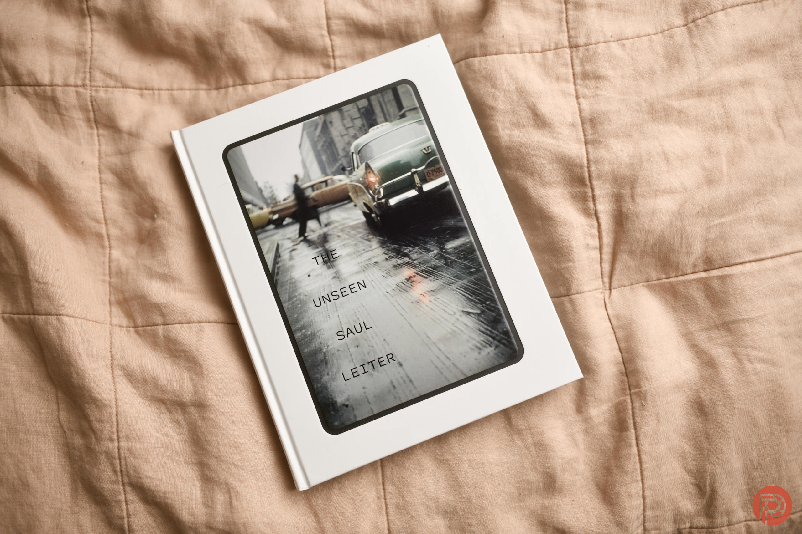 The Photographer That No One Should Copy A book titled The Unseen Saul Leiter rests on a beige quilted blanket.
