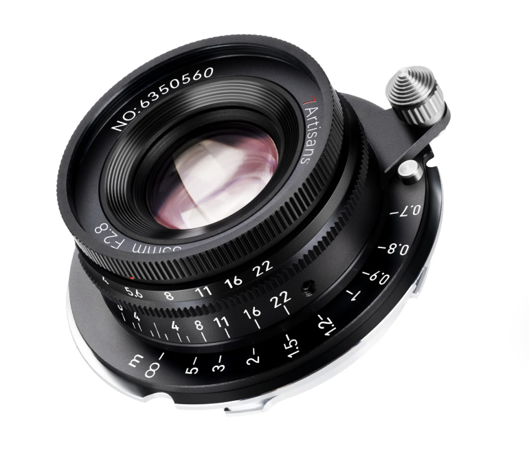 Close-up of a 7Artisans 35mm f/2.8 camera lens with aperture and focus markings visible.