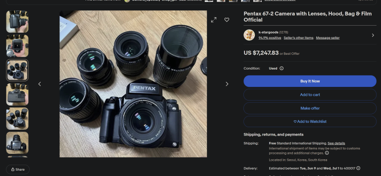 Pentax 67 camera with four lenses, a lens hood, and bag displayed on a wooden table.