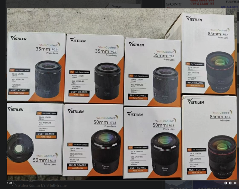 Eight boxed Vistilen camera lenses, including 35mm, 50mm, and 85mm models, displayed on a surface.