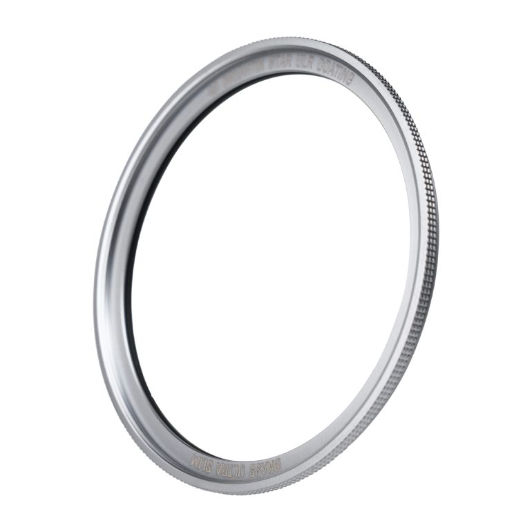 A close-up of a silver metal ring adapter with textured edges, isolated on a white background.