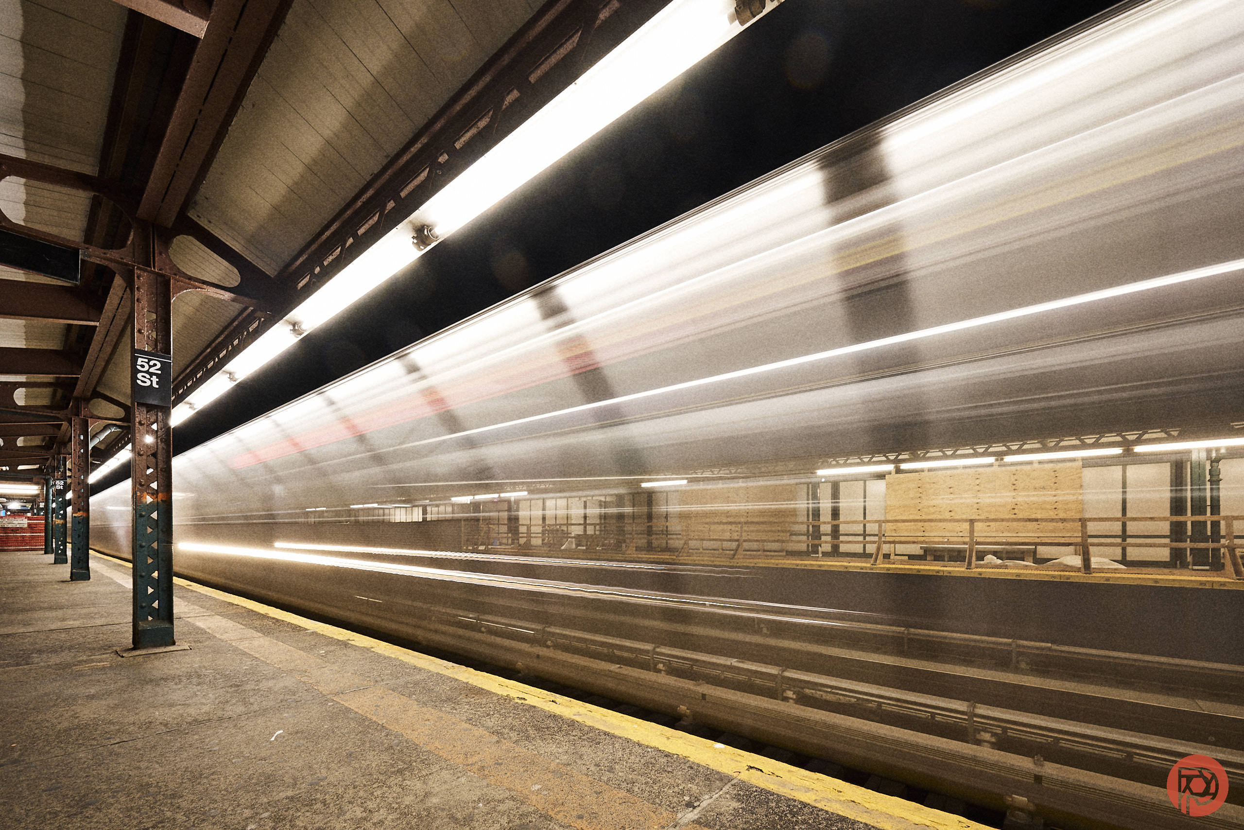 These are Some of the Best Presets You'll Own A subway train speeds through a dimly lit station with a 52 St sign and empty platform.
