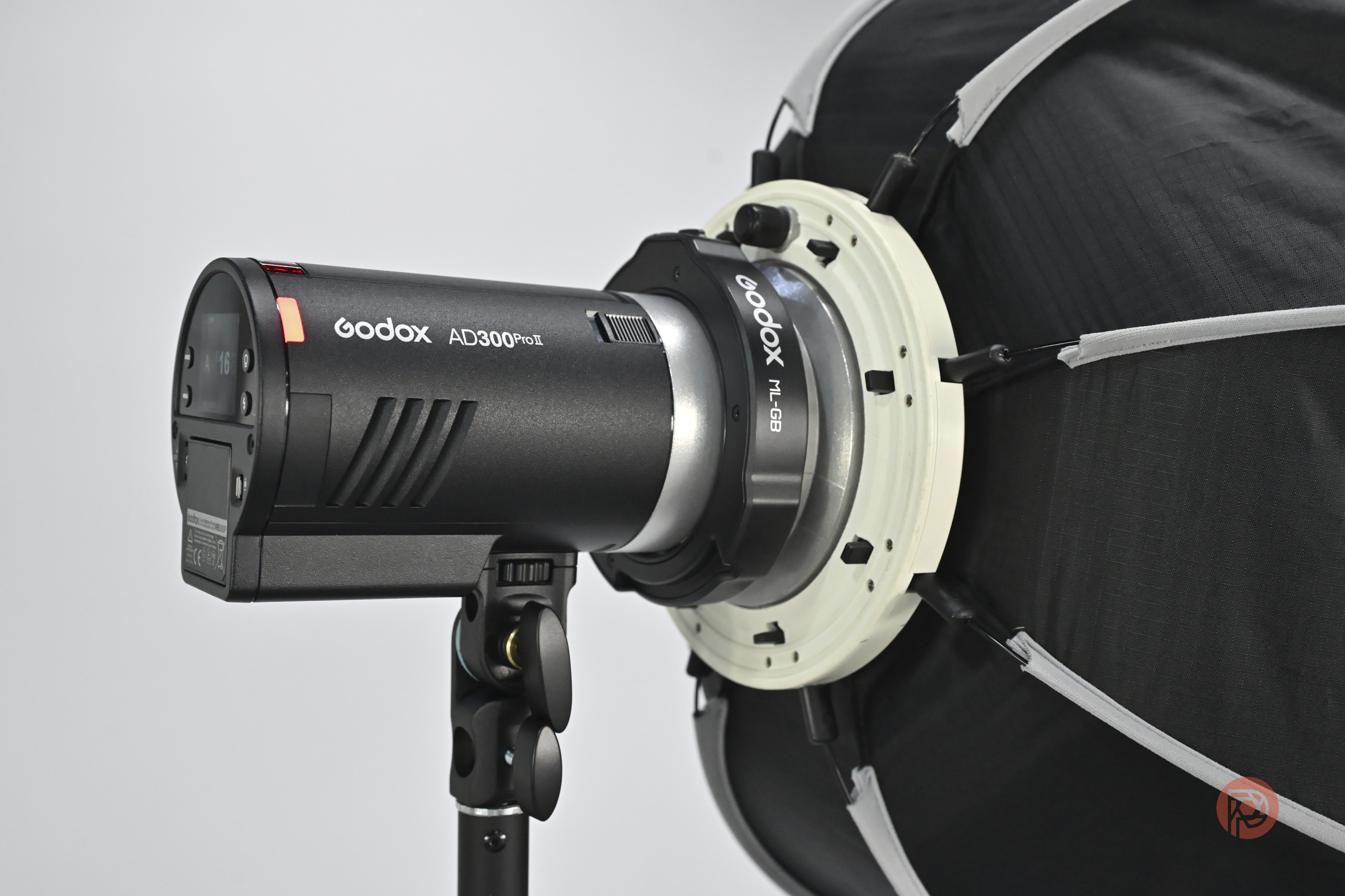 A Godox AD300Pro flash unit mounted on a light stand with a softbox attached.