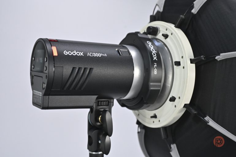 Godox AD300Pro studio flash with mounted softbox, attached to a black light stand against a white background.