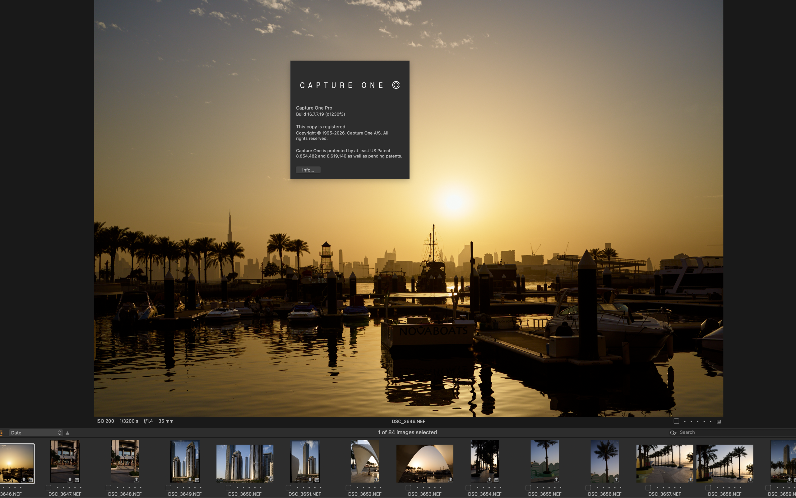 A marina at sunset with boats, palm trees, and a golden sky; Capture One software info box is visible.