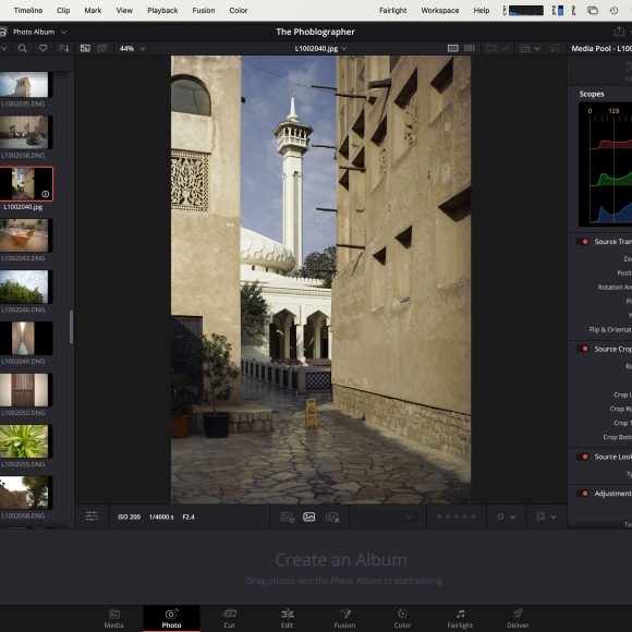 Editing software showing a photo of a narrow alley with a tower and mosque in daylight on the main screen.
