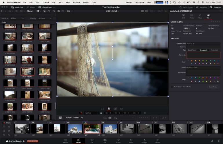 DaVinci Resolve interface showing a photo of tangled fishing net on a railing by the water in the preview window.
