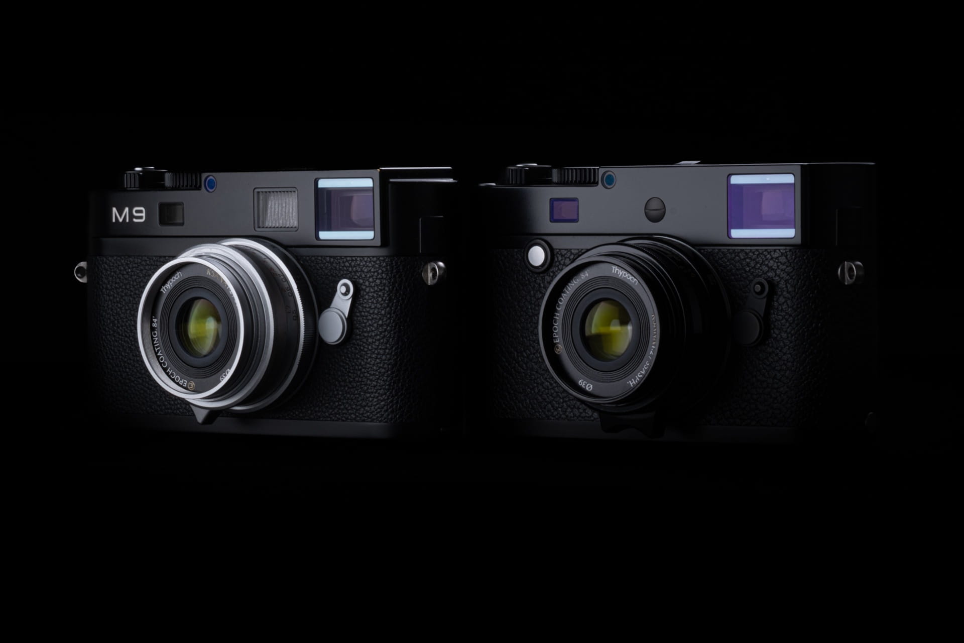 Thypoch’s Ksana 35mm F2 ASPH (M-Mount) Lens Promises Vintage Soul in a Modern Optic Two black vintage-style cameras with silver and black lenses, side by side against a dark background.