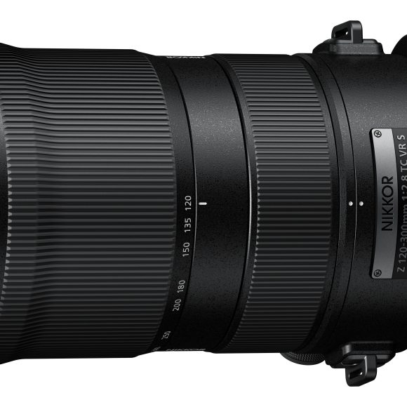 Large black Nikon camera lens with yellow accent, labeled NIKKOR Z 120-300mm f/2.8 S, viewed from the side.