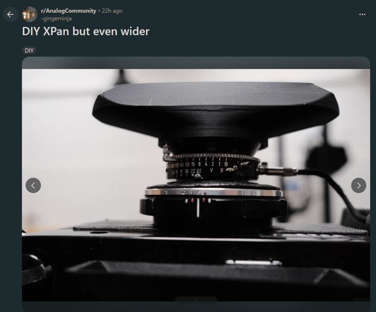 Close-up of a custom DIY panoramic camera with a wide, 3D-printed lens hood and focusing ring.