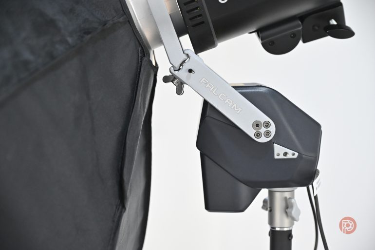 Close-up of a FALCAM studio light mounted on a stand with a softbox attached.