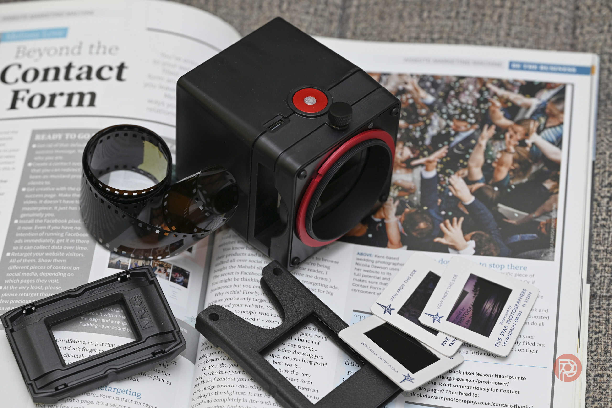 Valoi easy35 V2 Review: How Does the Perfect Scanning Tool Get Better? A film scanner, film negatives, and slides are placed on top of an open magazine.