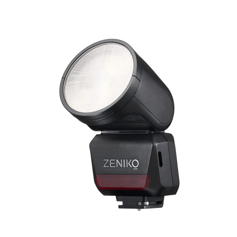 A black Zeniko camera flash unit with a large round head and a white diffuser.