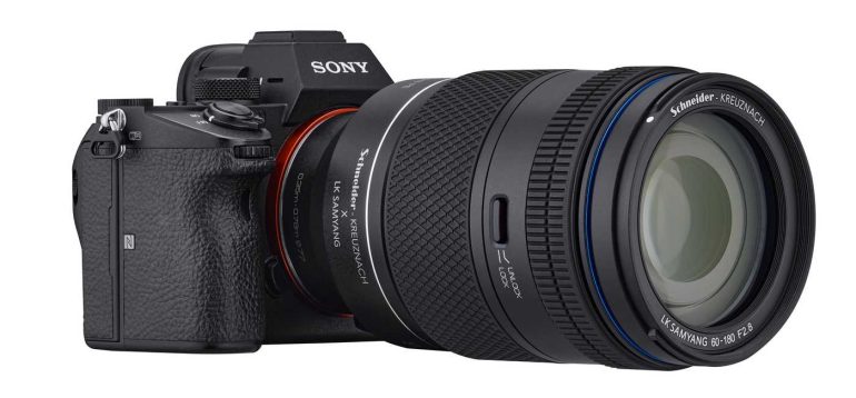 A black Sony digital camera with a large Schneider-Kreuznach lens attached, shown on a white background.