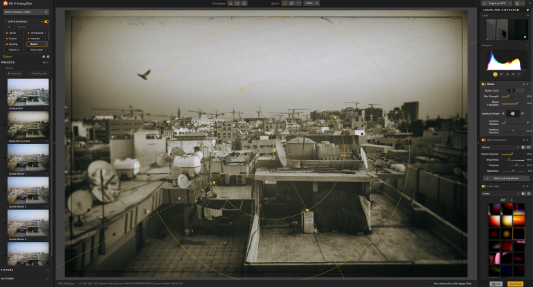 A sepia-toned cityscape photo is edited on a computer screen with various editing tools visible.