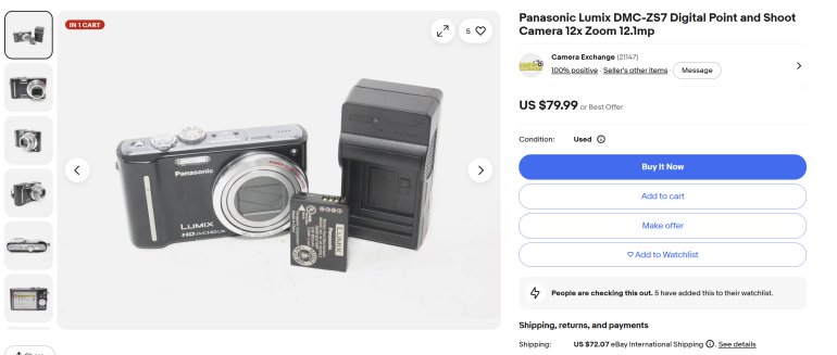 Panasonic Lumix DMC-ZS7 camera with battery and charger displayed on a white surface.