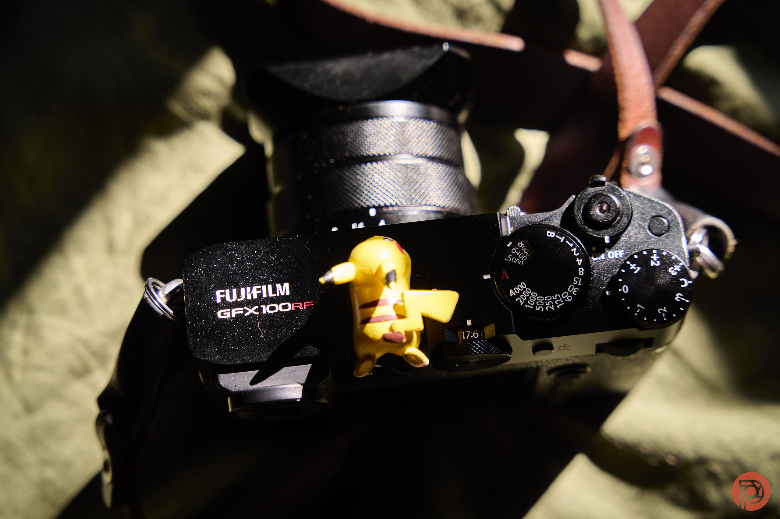 Fujifilm's Forgotten Camera Close-up of a Fujifilm GFX 100RF camera with a small Pikachu figure sitting on top.
