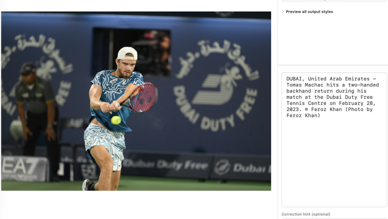 A tennis player in patterned sportswear hits a backhand shot during a match on a blue court.