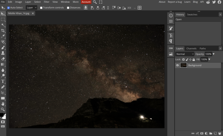 A night sky full of stars and the Milky Way above dark mountains, shown in a photo editing program.